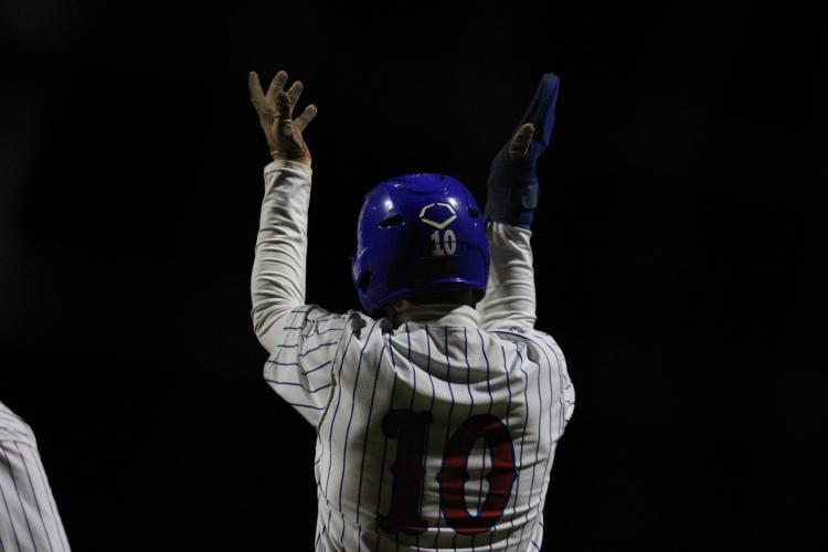 Oglethorpe County's Austin Lowe celebrates scoring a run against Lake Oconee Academy on Feb. 29. (Photo/Owen Warden)