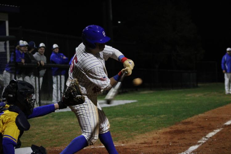 Oglethorpe County's Eli Ossick swings and is about to hit the ball against Lake Oconee Academy on Feb. 29. (Photo/Owen Warden)
