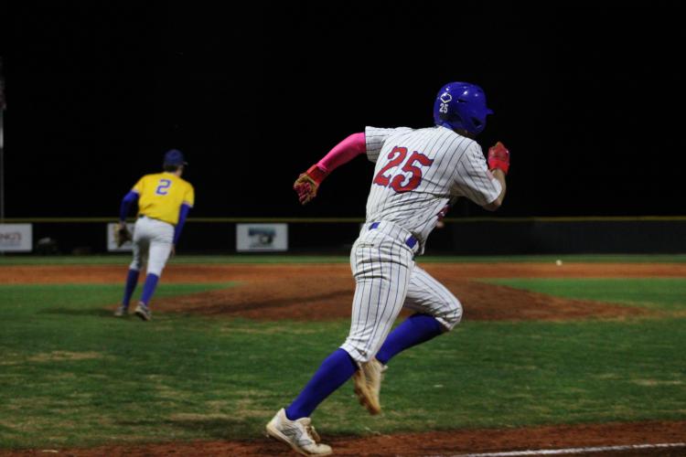 Outfielder Haiden Ashworth heads to first after getting a hit against Lake Oconee Academy last week. He leads OCHS with a .519 average and 13 RBIs through eight games. (Owen Warden/The Oglethorpe Echo)