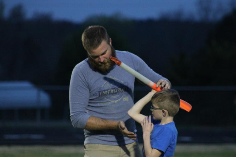 Assistant coach Craig Cheesborough works with Ty Crowe in throwing the javelin during rec department track and field practice at OCHS. More than 60 kids are participating in the first year of the program. (Owen Warden/The Oglethorpe Echo)
