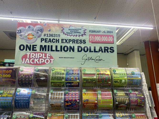 A sign in Peach Express in Crawford commemorates the $1 million jackpot won by an Oglethorpe County resident late last month. The resident wishes to remain anonymous.