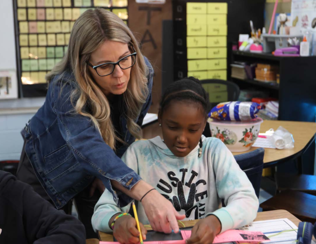 Katie Edwards, a counselor at Oglethorpe County Elementary School, helps third-grader Londyn Wilson with a work- sheet during a guidance lesson last month. The lessons are regularly held to guide students' empathy, emotion regulation, perseverance and more. (Navya Shukla/For The Oglethorpe Echo)