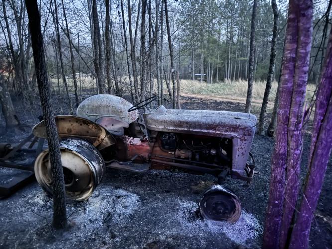 An older model Ford N-Series tractor was severely damaged during a fire on Yancey Road on March 20. The tractor was parked about 200 feet from where the fire started. (submitted photo)