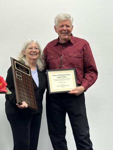 John Fortuna receives a certificate from Kathleen deMarrais, presi- dent of Historic Oglethorpe County after receiving the annual  Historic Oglethorpe County Annual Award at the organization’s banquet on March 1. (Photo/Izzy Wagner)