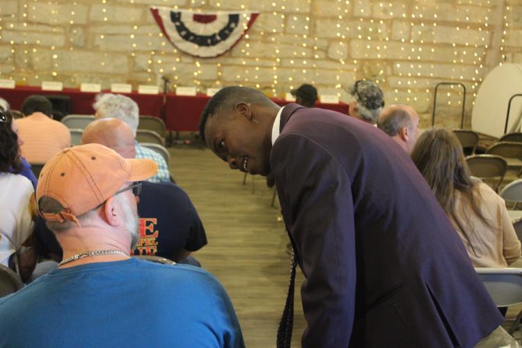 District 2 candidate Williamson Sintyl speaks with a resident during the meet and greet portion of the evening. He’s running against current county commissioner Andy Saxon in the general primary. (ABBY PEACOCK/THE OGLETHORPE ECHO)