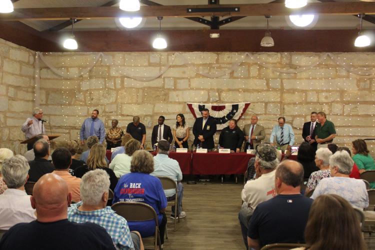 The 11 candidates who participated in the candidate forum stand at the conclusion of the event at the Historic Crawford Depot on April 18. About 100 people attended the event. (ABBY PEACOCK/THE OGLETHORPE ECHO)