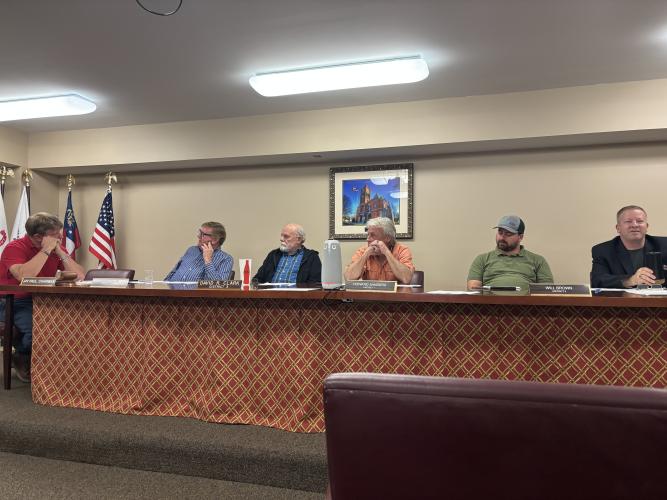 The Board of Commissioners preparing for the meeting on Monday evening. (Avi Young/The Oglethorpe Echo))