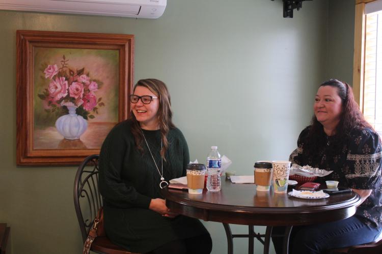 Laura Abbott (left) and Lisa Kesler attend the Town and Country Kafe's grand opening to celebrate the new restaurant and try the arepas, a signature Spanish-style dish. Abbott is the girlfriend of co-owner Josh Robayo. After seeing updates throughout the restaurant's renovation process, Keller is excited to finally see the finished building and try the menu items. (Sarah Myers/The Oglethorpe Echo)