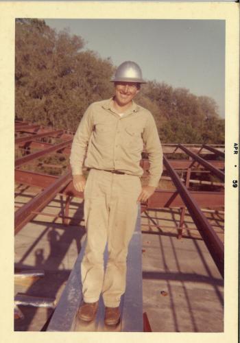 Ora Nation stands on the steel framework of a building while working for Rain- water Construction in 1959. Nation has worked at the company for 67 years, holding various roles from steel erector to building consultant over the course of his career. (Submitted Photo)