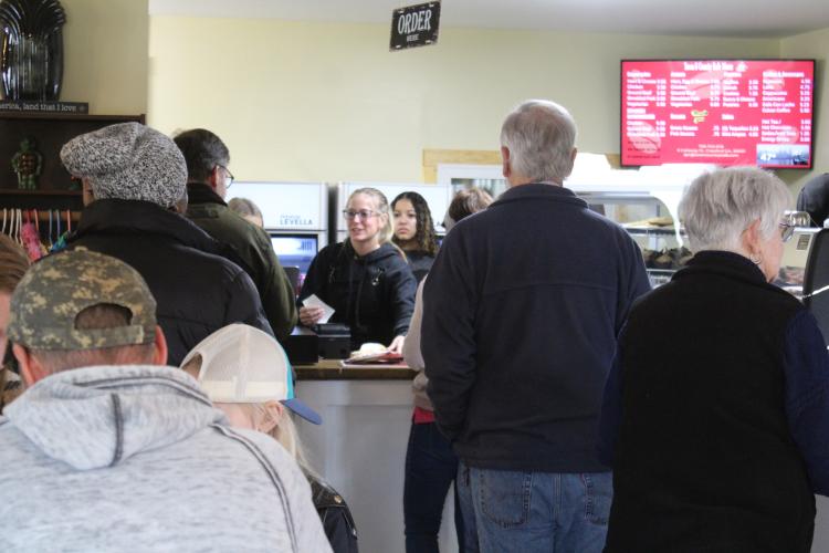 A crowd of customers fill Town and Country Kafe while attending the grand opening celebration on March 2. Weslynn Thurmond, a restaurant employee and junior at Oglethorpe County High School, takes orders during the event. (Sarah Myers/The Oglethorpe Echo)