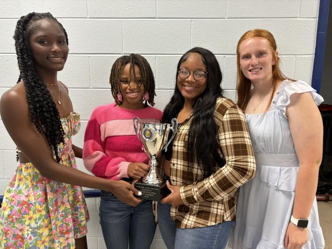 OCHS track athletes (from left) Kenzie Henderson, Sydnie Henderson, Zy Edwards and Abby Jones hold the Class A Division I state championship trophy. The Lady Patriots won their third state title in four years last weekend. (Andy Johnston/The Oglethorpe Echo)