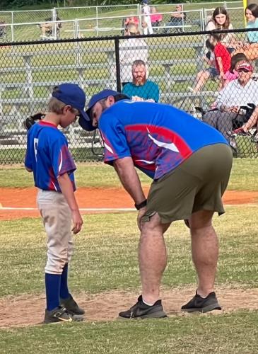 Brandy Haynie coaches his son Jackson Haynie in an Oglethorpe County Little League baseball game. Haynie said he has to balance his expectations with their perceptions of the sport when coaching his children. (Submitted Photo)