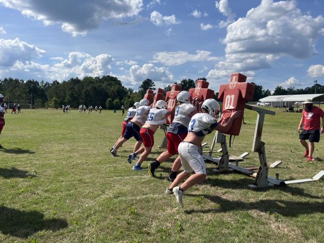 The offensive line works on their blocking technique during spring practice. (Hank Tatum/The Oglethorpe Echo)