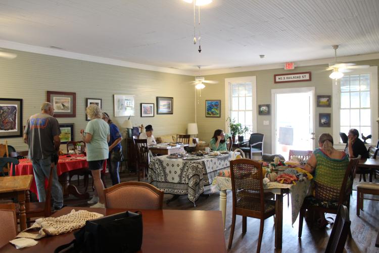 Locals gather at the Friends of the Oglethorpe Library book sale and art show at No. 3 Railroad. (Photo/Michael Johnson)