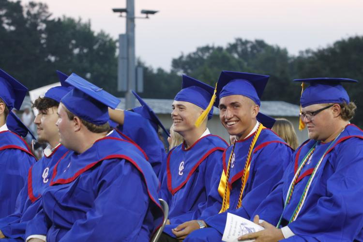 Graduates, including Jayden Wallace (from left), Jake Turner and Henry Throne, laugh during Principal Bill Sampson's speech about "standing on business," a popular phrase for this year's graduating class. (Torin Smith/The Oglethorpe Echo)