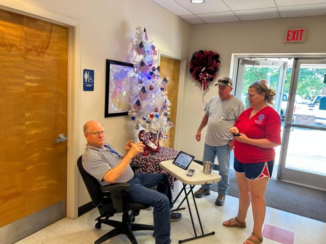 George Gray checks in Matt and Rhonda Holt, who live in Palmetto, at the Oglethorpe County Elections Office on Tuesday, May 21, 2024. (Zeke Palermo/The Oglethorpe Palermo)