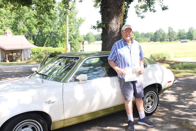 Donald Chandler holds the original receipts and paperwork for the 51-year-old Ford Pinto he bought new in 1973. The car won "Best Antique" at the Winterville Marigold Festival Parade last month. (Sarah Coyne/The Oglethorpe Echo)