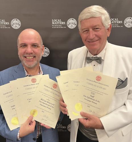 Andy Johnston (left), editor of The Oglethorpe Echo, and Dink NeSmith, chairman of The Oglethorpe Echo Legacy Inc., display the awards won at this year’s Georgia Press Association convention on June 7. The Echo has won 18 GPA awards in its two full years partnering with UGA’s Grady College of Journalism and Mass Communication. (Lori Johnston/The Oglethorpe Echo)