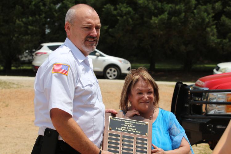 Arnoldsville Fire Chief Heath Baker and Melissa Koscinski pose with the Firefighter of the Year award, dedicated to John Knack. (Torin Smith/The Oglethorpe Echo)