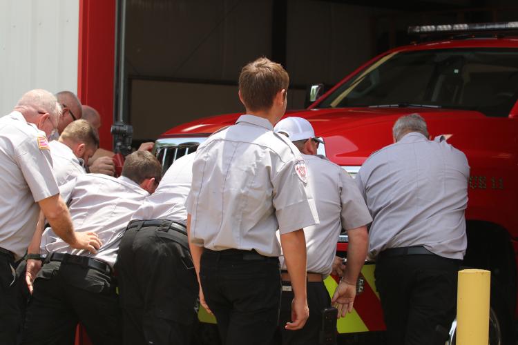 Members of the Arnoldsville Volunteer Fire Department held a push-in ceremony for the new truck on Saturday. The push-in is a tradition for stations across the country where the firefighters push a new truck into the bay to officially put it into service. (Torin Smith/The Oglethorpe Echo)