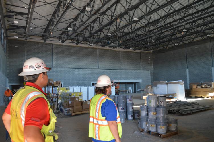 Spencer Sato and Paul Thiel look at the unfinished gymnasium in the new Oglethorpe County Elementary School. Thiel said the project is on-time and on-budget. (McCain Bracewell/The Oglethorpe Echo)