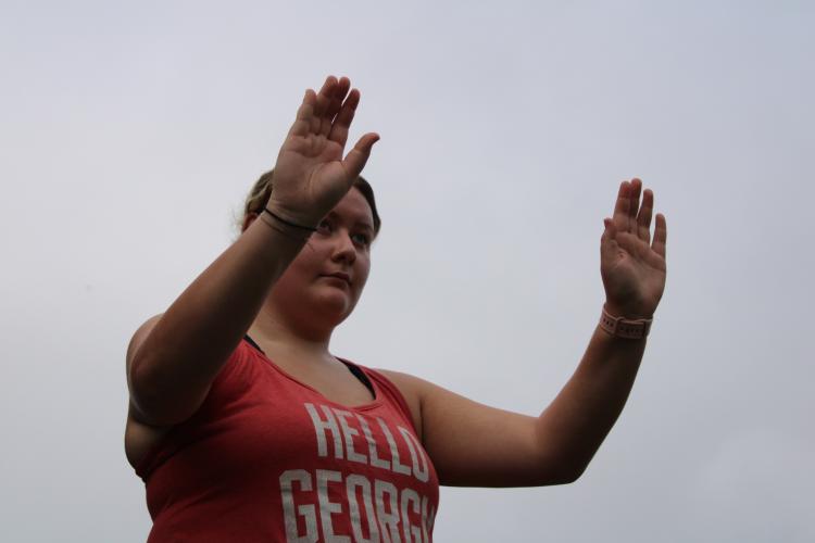 Kendall McCurdy conducts the marching band through their first part of the show. This is her first season being drum major. (Sarah Coyne/The Oglethorpe Echo)