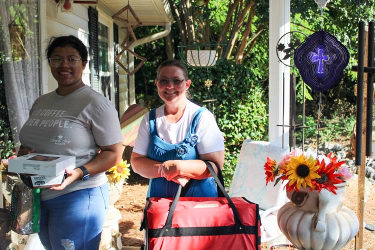 Volunteer Delsia Summerall (left) and Amanda York, the home delivery meals coordinator visit their first house on a recent Tuesday. The Oglethorpe County Senior Center delivers meals to residents throughout the county Monday through Wednesday every week. (Sarah Coyne/The Oglethorpe Echo)
