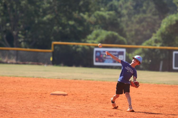 Sam Wisham works on fielding ground balls and throwing to first base in the baseball camp at OCHS. He was one of 35 boys who participated.  (Torin Smith/The Oglethorpe Echo)
