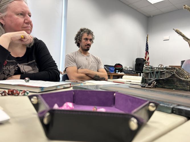 Pam Mitchell (left) and John Lombardi listen to their dungeon master during a Dungeons &amp; Dragons game at the Oglethorpe County Library. The library will hold its final D&amp;D session of the summer at 11 a.m. on July 20. (Zeke Palermo/The Oglethorpe Echo)