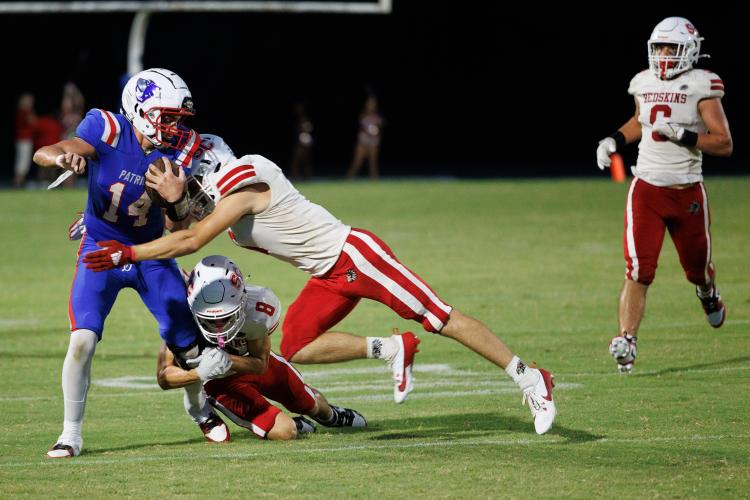 OCHS receiver Jackson Tatum tries to evade Social Circle’s Jude Nelson (8) and Levi Kendall in the season-opener on Aug. 16. Tatum had two catches for 15 yards. (Mark/The Oglethorpe Echo)