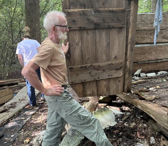 James Bennett stands at the door of a historic log cabin his team is deconstructing. Lucas Stephens stands in the background. (MCCAIN BRACEWELL/THE OGLETHORPE ECHO)