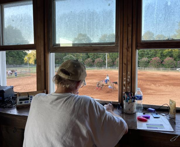Oglethorpe County Saddle Club President Lorrie Bass times competitors in Saturday's Buckle Series show. The Buckle Series is held the fourth Saturday of each month, March through October. (Photo/Ella Kroll)