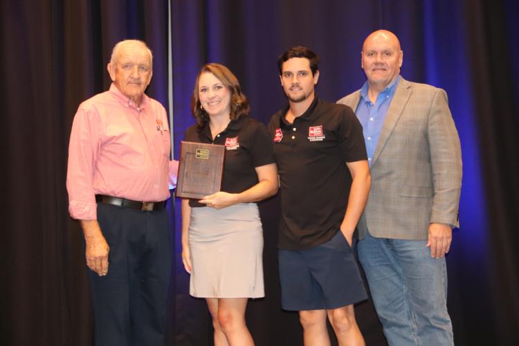 Winterville’s Kaitlyn and Kaleb Marchant (middle) receive the Georgia Farm Bureau Young Farmers &amp; Ranchers Achievement Award from Georgia Farm Bureau president Tom McCall (left) and Tony Hutchins (right) of Southern Farm Bureau Life Insurance. The Marchants represent the 4th District on the organization’s Young Farmers &amp; Ranchers Committee. (SUBMITTED PHOTO/GEORGIA FARM BUREAU)