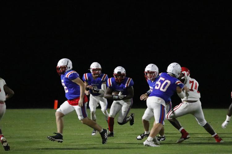 Running back Payton Prince finds an opening through the line on his way to picking up yards in Oglethorpe County’s scrimmage against Lincoln County last week. The Patriots open the season against Social Circle at home on Friday. (Torin Smith/The Oglethorpe Echo)
