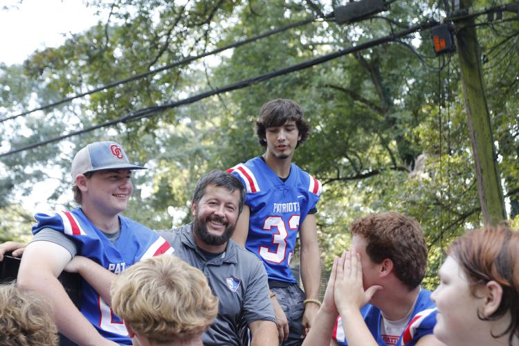 Members of the Oglethorpe County High School football team smile on the back of their float during the homecoming parade on Sept. 19, 2024 in downtown Crawford. (Photo/ McCain Bracewell)