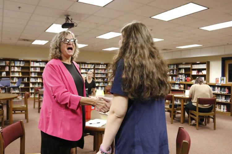 Joyce Sniff, a retired CPA, greets Jasmine Hooper from the healthcare class at Oglethorpe County High School on Wednesday, Sept. 4, 2024. OCHS hosted mock job interviews to give students a leg up in career preparedness. (McCain Bracewell/The Oglethorpe Echo)