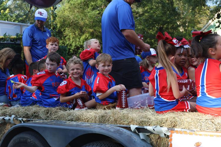Oglethorpe County rec league football players, cheerleaders and coaches fill a float to take part in Oglethorpe County High School Homecoming Parade in downtown Crawford on Sept. 19, 2024. (Photo/Avni Trivedi)