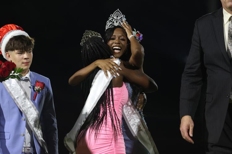 The 2024 Oglethorpe County High School homecoming queen Paris Crowder hugs the 2023 Oglethorpe County homecoming queen Aariana Bell after Crowder was crowned during halftime of the homecoming football game against Elbert County High School on Friday, Sept. 20, 2024. (Photo/Avni Trivedi)