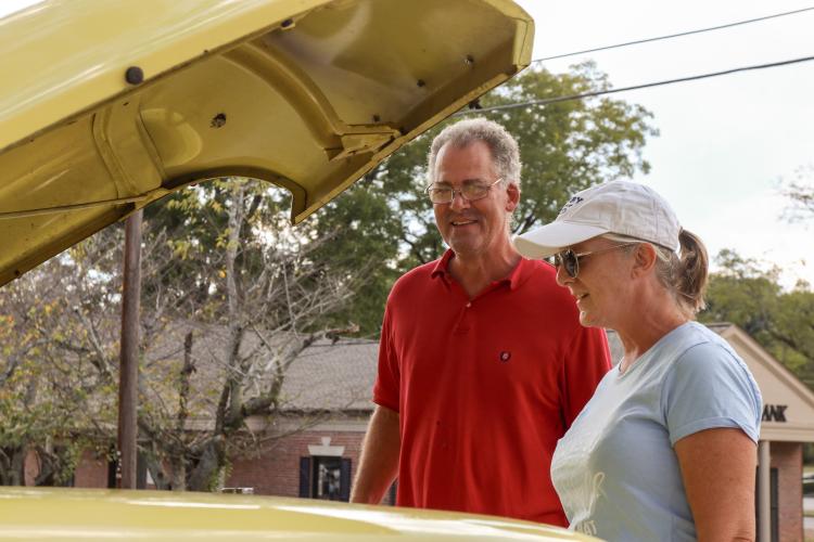Kip (left) and Marian (right) Smith examine the engine of a car at the Firefly Cruise-In at the Oglethorpe County Courthouse, Sept. 22, 2024. The car show showcased vintage as well as newer cars, with a $10 registration fee to enter each vehicle. (Kendall Kelly/Oglethorpe Echo)