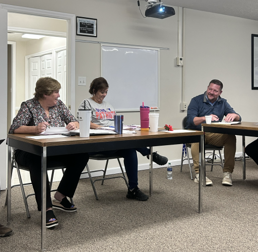 Superintendent Beverley Levine (from left), administrative assistant Sue Ann Blalock and EMS Director Jason Lewis chat at the BOE’s work session on Tuesday. The BOE approved two school resource officers, pending approval from the Board of Commissioners. (McCain Bracewell/ The Oglethorpe Echo)