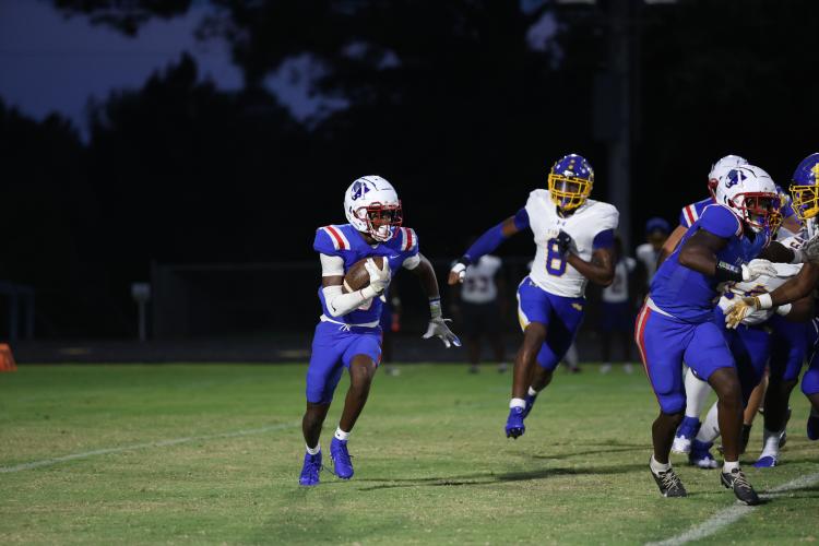 OCHS quarterback Darius Heard scoots around the end on his way to rushing for 116 yards in a 20-17 loss to Washington-Wilkes on Aug. 30. Heard led the Patriots in rushing and scored two TDs. (TY JOHNSTON/THE OGLETHORPE ECHO)