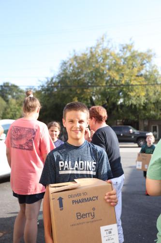 Eli Roberts, 12, helps carry donations at the Lexington Fire Department on Aug. 30. His family lost their home near Lexington when it burned on Aug. 27. (TY JOHNSTON/THE OGLETHORPE ECHO)