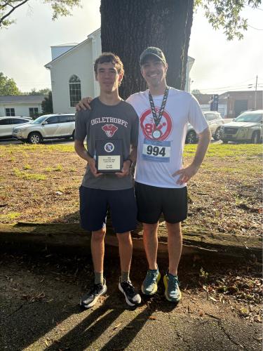 Cory Tillman and his father Glenn Tillman pose after finishing the 20th annual Restoration Labor Day 5K. Cory was first overall and Glenn finished sixth, first in his age group (40-49). (Submitted Photo)