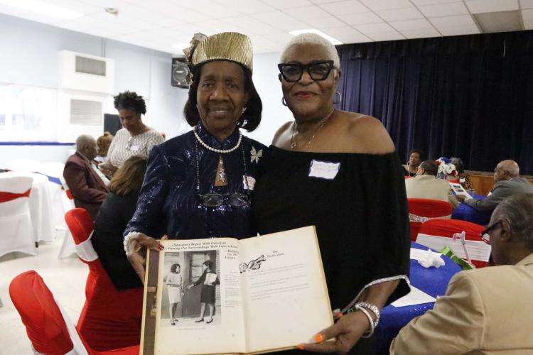 Betty Williamson and Joyce Smith stand with the first edition of the Oglethorpe County Consolidated School yearbook at the commemorative program on Saturday. Williamson taught at OCCS in 1968 and helped start the yearbook. Smith was one of the co-editors of the yearbook and is pictured in the book (right). (McCain Bracewell/The Oglethorpe Echo)