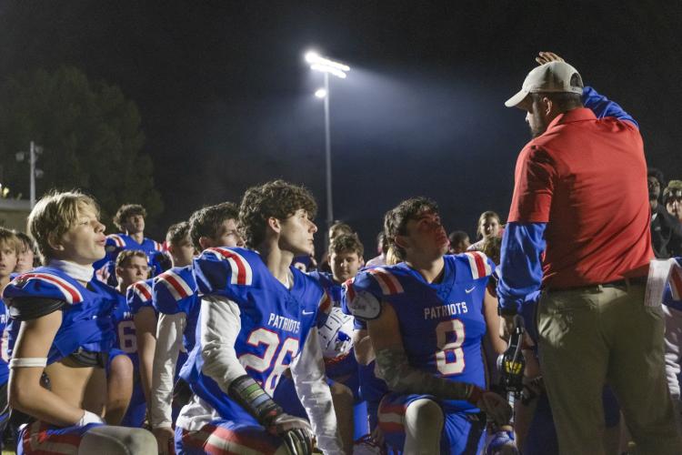 Oglethorpe County coach Mike Holland speaks to his players following their 55-14 loss to Commerce on Oct. 19. The Patriots fell to 0-8 this season heading into this week’s game at Providence. (WOODY LOFTON/THE OGLETHORPE ECHO)