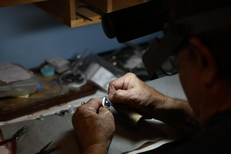 Bobby Teller polishes a handcrafted ring for his wife, Donna. He does his work in his guest bedroom at his home in Crawford. (TY JOHNSTON/THE OGLETHORPE ECHO)