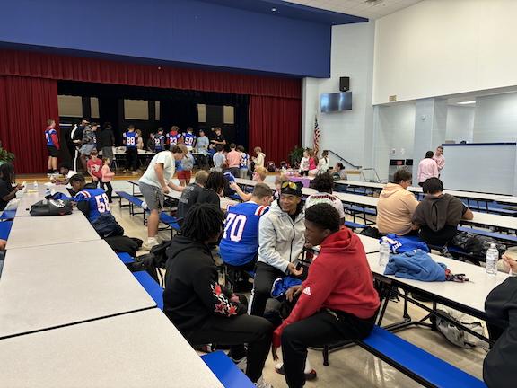 Before games on Friday nights, the Oglethorpe County football team congregates in the school’s cafeteria for a pregame meal donated by a local sponsor. Local churches have played the biggest role in meal donations, OCHS coach Mike Holland said. (JACK KEYS/THE OGLETHORPE ECHO)