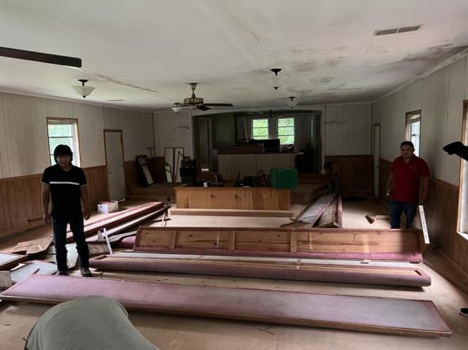 Workers take apart the pews in the former Russell Chapel AME Church building in Lexington. The pews and pastor chairs were donated to a start-up church in Mexico. (Submitted Photo)