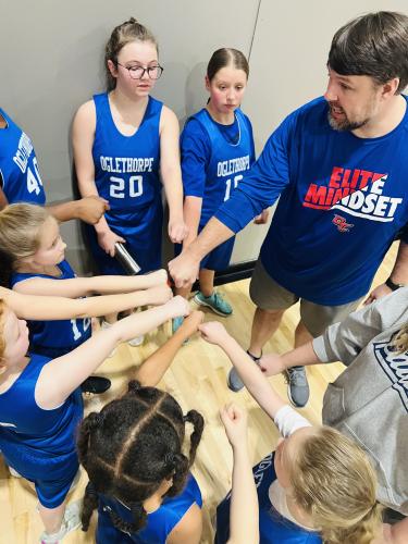 Carey Paul gathers his rec basketball team in a huddle. Paul has been an active coach in the community since 2012. (The Oglethorpe Echo/Submitted Photo)