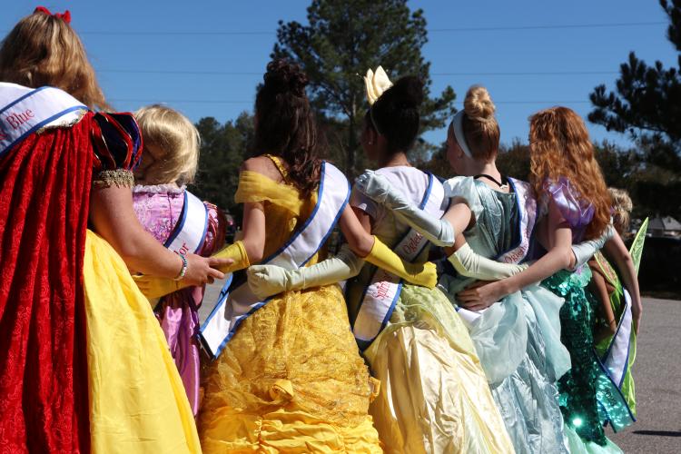Miss Oglethorpe winners and contestants from past years pose for a photo at Madison Oglethorpe Animal Shelter on Saturday, Oct. 19. The Miss Oglethorpes dressed as Disney princesses for the Halloween Costume Party event, whose main goal was to increase visibility of dogs in the shelter that can be fostered and adopted. "We can't do this without the community's help," MOAS volunteer Kelly Wall said. (Ella Kroll/The Oglethorpe Echo)